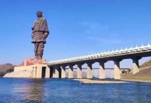 The majestic Statue of Unity towering over the scenic Narmada River, the monumental highlight of our 2-day Gujarat tour package.