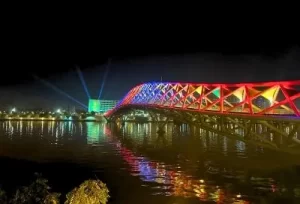 The beautifully illuminated Atal Pedestrian Bridge spanning the Sabarmati River at night, a modern architectural highlight of our 3-day Ahmedabad tour.