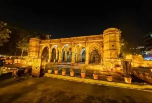 The intricately carved and illuminated Sidi Saiyyed Mosque at night, a featured heritage destination on the 3-day Ahmedabad and Vadodara tour package