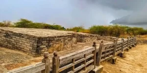 The geometric brick foundations and excavated urban ruins of the Lothal archaeological site, explored during a private Indus Valley day trip from Vadodara.