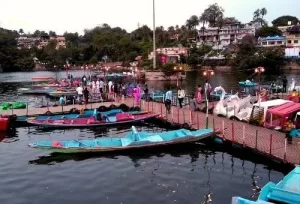 Colorful boats floating on the serene Nakki Lake in Mount Abu, the picturesque hill station starting point for our Rajasthan circular tour packages.